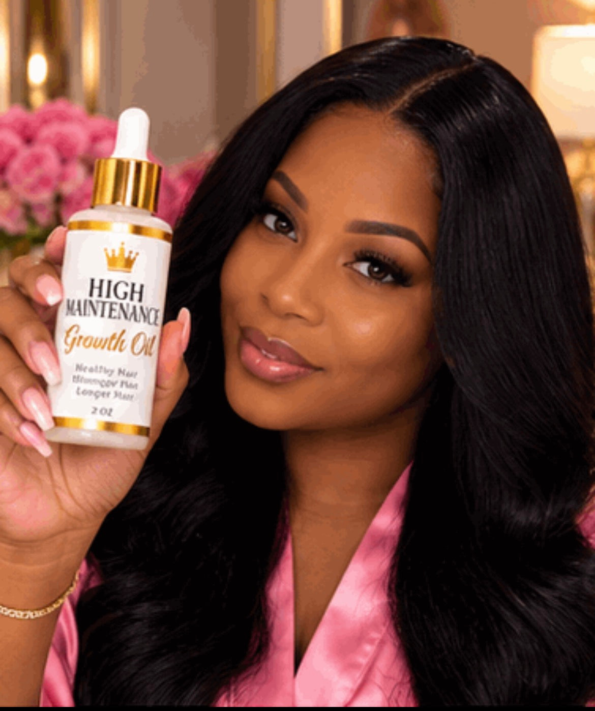 Woman holding the bottle: “Woman with long black hair holding a bottle of High Maintenance Growth Oil.”